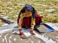 A woman dries grain in the sun in Sainji Village (Corn Village) in Mussoorie, Uttarakhand, India, on April 18, 2024. This village is famous...