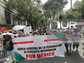 Judiciary workers block the streets near the Senate of Mexico, blocking access to legislators, while demonstrating to protest against the Ju...