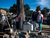 Truck drivers and their relatives take part in a community lunch and camp in northern Bogota, as truckers demonstrate against the increase i...