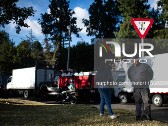 Truck drivers and their relatives take part in a community lunch and camp in northern Bogota, as truckers demonstrate against the increase i...