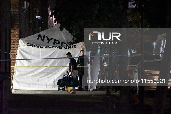 Crime scene investigators place evidence markers at the scene where 26-year-old male Mario Guerrero is shot in the head and pronounced dead...