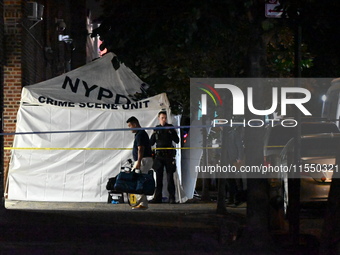 Crime scene investigators place evidence markers at the scene where 26-year-old male Mario Guerrero is shot in the head and pronounced dead...