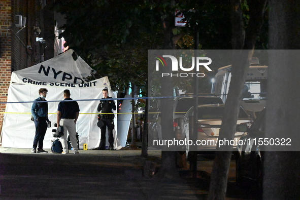 Crime scene investigators place evidence markers at the scene where 26-year-old male Mario Guerrero is shot in the head and pronounced dead...