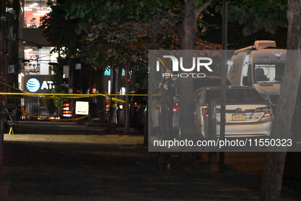 Crime scene investigators place evidence markers at the scene where 26-year-old male Mario Guerrero is shot in the head and pronounced dead...