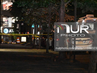 Crime scene investigators place evidence markers at the scene where 26-year-old male Mario Guerrero is shot in the head and pronounced dead...