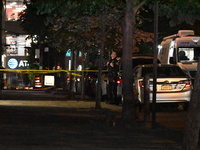 Crime scene investigators place evidence markers at the scene where 26-year-old male Mario Guerrero is shot in the head and pronounced dead...