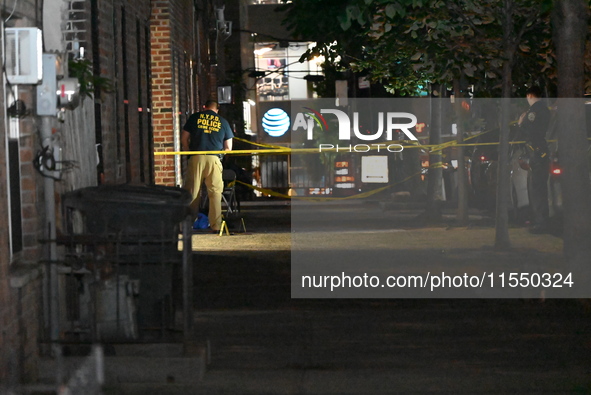 Crime scene investigators place evidence markers at the scene where 26-year-old male Mario Guerrero is shot in the head and pronounced dead...