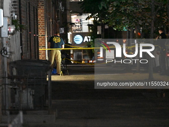 Crime scene investigators place evidence markers at the scene where 26-year-old male Mario Guerrero is shot in the head and pronounced dead...