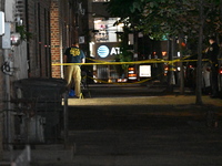 Crime scene investigators place evidence markers at the scene where 26-year-old male Mario Guerrero is shot in the head and pronounced dead...