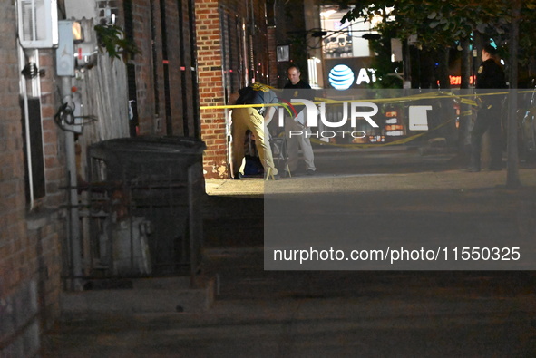 Crime scene investigators place evidence markers at the scene where 26-year-old male Mario Guerrero is shot in the head and pronounced dead...