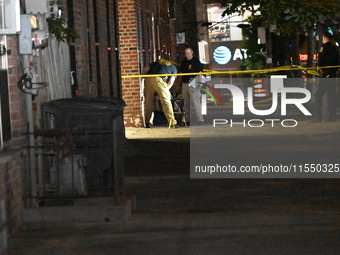 Crime scene investigators place evidence markers at the scene where 26-year-old male Mario Guerrero is shot in the head and pronounced dead...