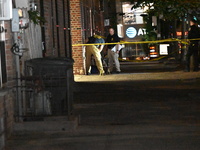 Crime scene investigators place evidence markers at the scene where 26-year-old male Mario Guerrero is shot in the head and pronounced dead...