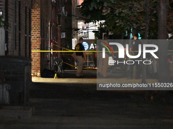 Crime scene investigators place evidence markers at the scene where 26-year-old male Mario Guerrero is shot in the head and pronounced dead...