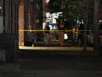 Crime scene investigators place evidence markers at the scene where 26-year-old male Mario Guerrero is shot in the head and pronounced dead...