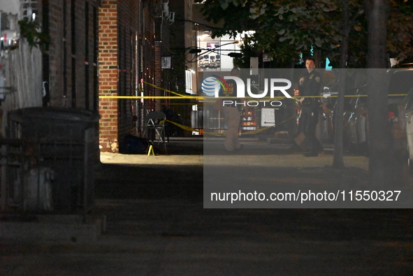 Crime scene investigators place evidence markers at the scene where 26-year-old male Mario Guerrero is shot in the head and pronounced dead...