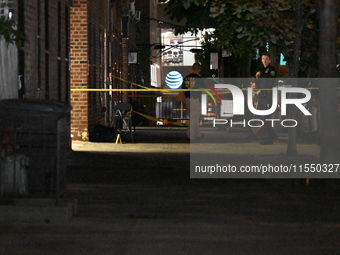 Crime scene investigators place evidence markers at the scene where 26-year-old male Mario Guerrero is shot in the head and pronounced dead...