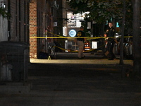 Crime scene investigators place evidence markers at the scene where 26-year-old male Mario Guerrero is shot in the head and pronounced dead...