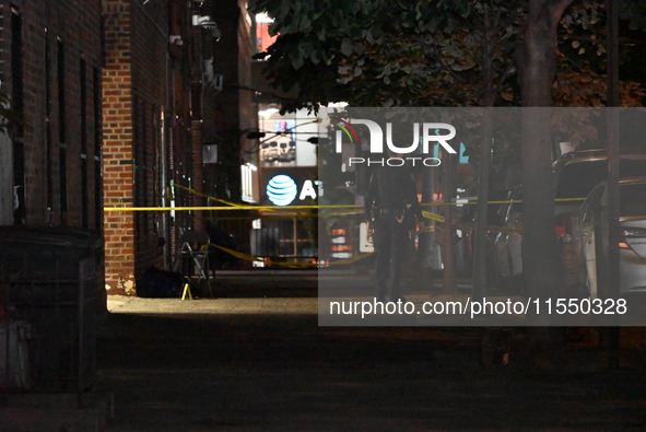 Crime scene investigators place evidence markers at the scene where 26-year-old male Mario Guerrero is shot in the head and pronounced dead...