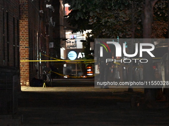 Crime scene investigators place evidence markers at the scene where 26-year-old male Mario Guerrero is shot in the head and pronounced dead...