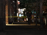 Crime scene investigators place evidence markers at the scene where 26-year-old male Mario Guerrero is shot in the head and pronounced dead...