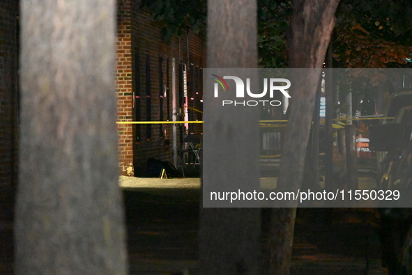 Crime scene investigators place evidence markers at the scene where 26-year-old male Mario Guerrero is shot in the head and pronounced dead...