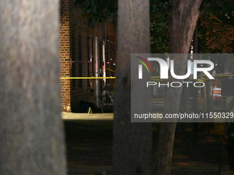 Crime scene investigators place evidence markers at the scene where 26-year-old male Mario Guerrero is shot in the head and pronounced dead...