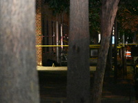 Crime scene investigators place evidence markers at the scene where 26-year-old male Mario Guerrero is shot in the head and pronounced dead...