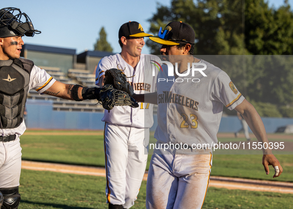 The Yolo High Wheelers celebrate clinching their spot in the 2024 Pioneer Baseball League Playoffs at Dobbins Stadium in Davis, Calif., on S...