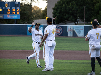 The Yolo High Wheelers celebrate clinching their spot in the 2024 Pioneer Baseball League Playoffs at Dobbins Stadium in Davis, Calif., on S...