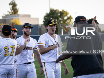 The Yolo High Wheelers celebrate clinching their spot in the 2024 Pioneer Baseball League Playoffs at Dobbins Stadium in Davis, Calif., on S...