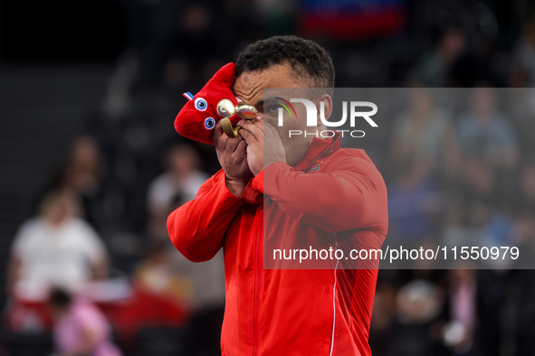 Mohamed Elmenyawy celebrates during the victory ceremony for the para Powerlifting Men's up to 59kg final event at the Paris 2024 Paralympic...