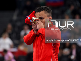 Mohamed Elmenyawy celebrates during the victory ceremony for the para Powerlifting Men's up to 59kg final event at the Paris 2024 Paralympic...