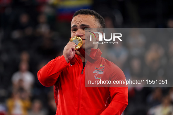 Mohamed Elmenyawy celebrates during the victory ceremony for the para Powerlifting Men's up to 59kg final event at the Paris 2024 Paralympic...