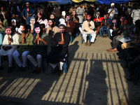 People hold placards with the faces of martyrs at the 'Shohidra Fire Ashche' event, held in memory of those killed in the anti-discriminatio...