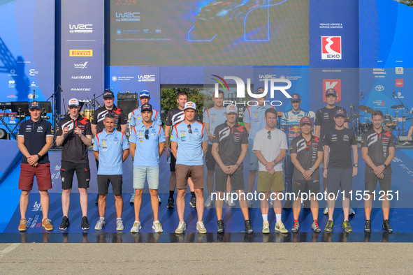 A family faces the ceremonial start during the FIA World Rally Championship WRC EKO Acropolis Rally Greece in Lamia, Greece, on September 5,...