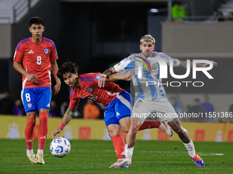 Victor Davila of Chile and Rodrigo de Paul of Argentina are in action during the FIFA World Cup 2026 Qualifier match between Argentina and C...