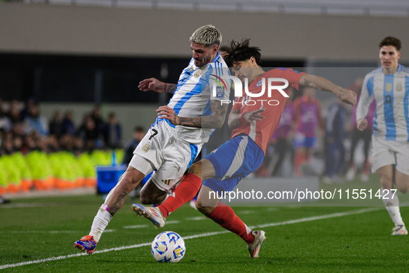 Rodrigo de Paul of Argentina and Victor Davila of Chile are in action during the FIFA World Cup 2026 Qualifier match between Argentina and C...