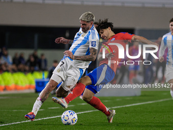 Rodrigo de Paul of Argentina and Victor Davila of Chile are in action during the FIFA World Cup 2026 Qualifier match between Argentina and C...