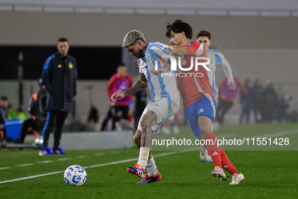 Rodrigo de Paul of Argentina and Victor Davila of Chile are in action during the FIFA World Cup 2026 Qualifier match between Argentina and C...