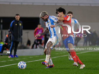 Rodrigo de Paul of Argentina and Victor Davila of Chile are in action during the FIFA World Cup 2026 Qualifier match between Argentina and C...