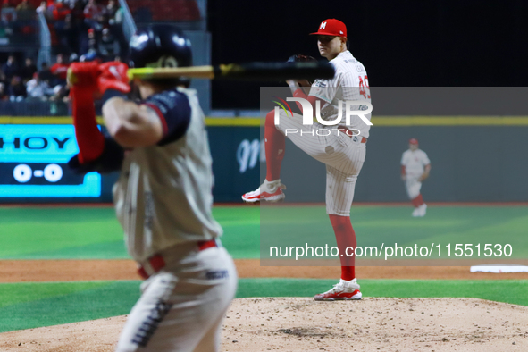 Erick Leal #49 of Diablos Rojos pitches the ball against Javier Salazar #2 of Sultanes de Monterrey during match 2 between Sultanes de Monte...