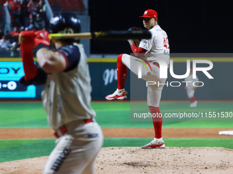 Erick Leal #49 of Diablos Rojos pitches the ball against Javier Salazar #2 of Sultanes de Monterrey during match 2 between Sultanes de Monte...