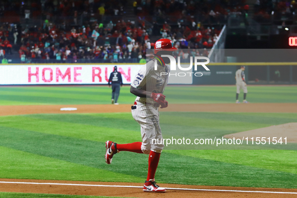 Aristides Aquino #56 of Diablos Rojos runs to home plate against Sultanes de Monterrey during match 2 between Sultanes de Monterrey and Diab...