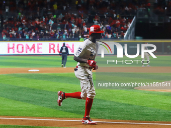 Aristides Aquino #56 of Diablos Rojos runs to home plate against Sultanes de Monterrey during match 2 between Sultanes de Monterrey and Diab...