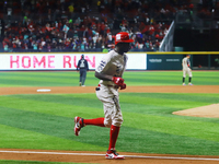 Aristides Aquino #56 of Diablos Rojos runs to home plate against Sultanes de Monterrey during match 2 between Sultanes de Monterrey and Diab...