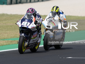 Senna Agius of Australia and Liqui Moly Husqvarna Intact GP rides on track in front of Barry Baltus of Belgium and RW Racing GP during Moto2...