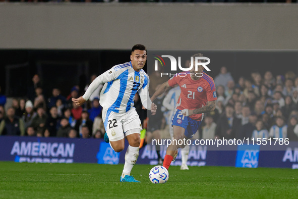 Lautaro Martinez of Argentina and Matias Catalan of Chile are in action during the FIFA World Cup 2026 Qualifier match between Argentina and...