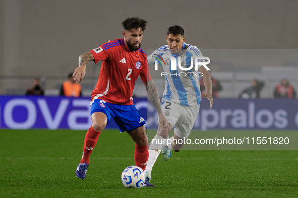 Eugenio Mena of Chile and Nahuel Molina of Argentina are in action during the FIFA World Cup 2026 Qualifier match between Argentina and Chil...