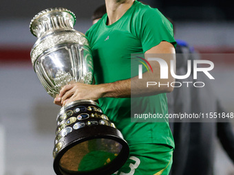 Emiliano Martinez of Argentina celebrates with the Copa America 2024 trophy after the FIFA World Cup 2026 Qualifier match between Argentina...