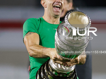 Emiliano Martinez of Argentina celebrates with the Copa America 2024 trophy after the FIFA World Cup 2026 Qualifier match between Argentina...